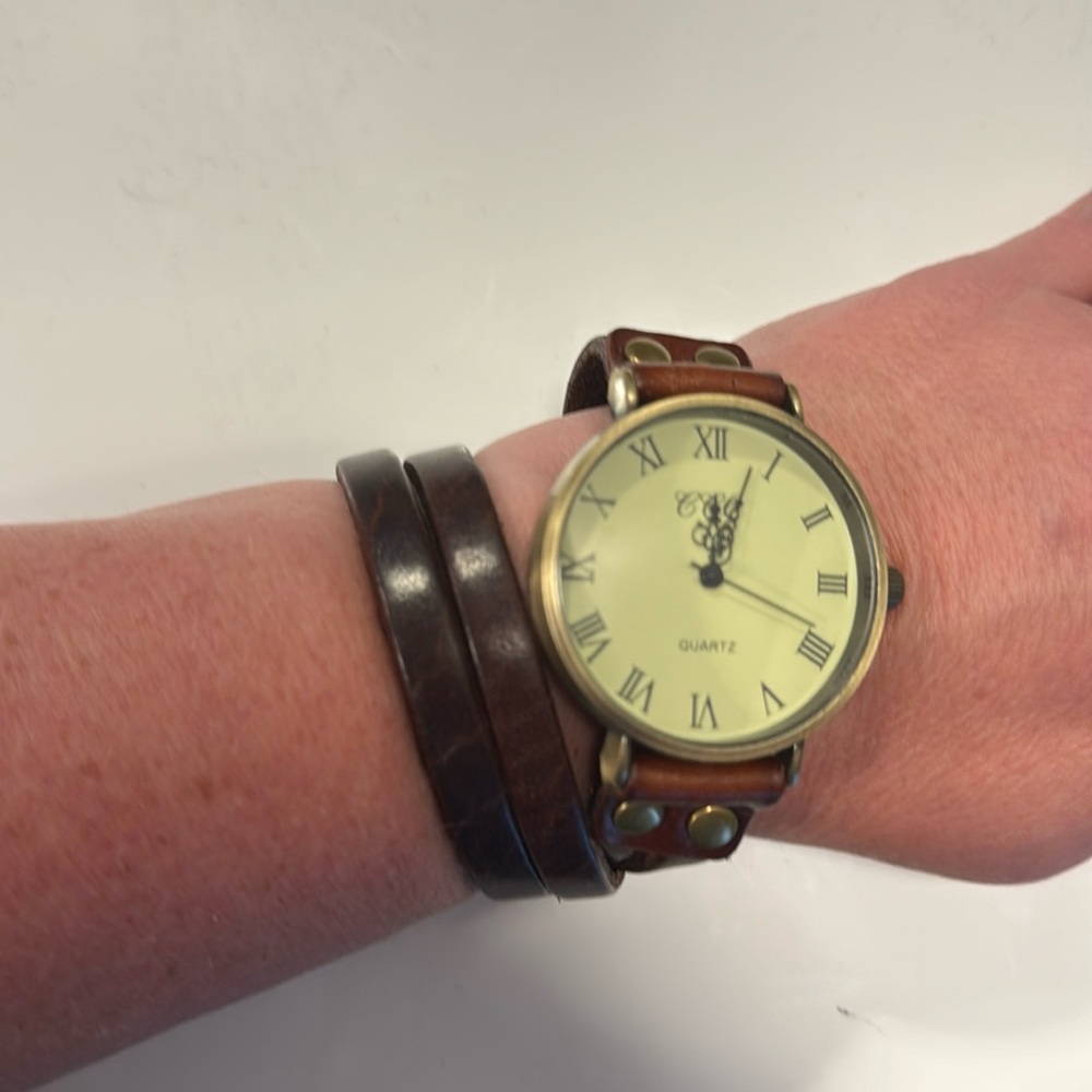CCQ wrap around watch with brown leather strap.  Never used so battery is new